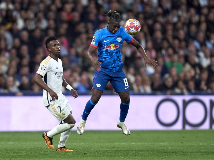 MADRID, SPAIN - MARCH 06: Vinicius Junior of Real Madrid battles for the ball with Amadou Haidara of Leipzig during the UEFA Champions League 2023/24 round of 16 second leg match between Real Madrid CF and RB Leipzig at Estadio Santiago Bernabeu on March 06, 2024 in Madrid, Spain. (Photo by Diego Souto/Getty Images)