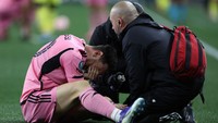 Messi masih memperlihatkan ekspresi kesakitan saat mendapatkan perawatan dari tim medis di atas lapangan. Foto: Getty Images/Donald Page