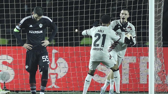 Leverkusens Florian Wirtz and Amine Adli celebrate after scoring their sides second goal scored by Patrik Schick during the Europa League round of sixteen, first leg, soccer match between Qarabag and Leverkusen at the Tofiq Bahramov Republican stadium in Baku, Azerbaijan, Thursday, March 7, 2024. (AP Photo)