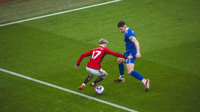 MANCHESTER, ENGLAND - MARCH 09: Alejandro Garnacho of Manchester United is fouled by James Tarkowski of Everton FC during the Premier League match between Manchester United and Everton FC at Old Trafford on March 09, 2024 in Manchester, England. (Photo by Ash Donelon/Manchester United via Getty Images)