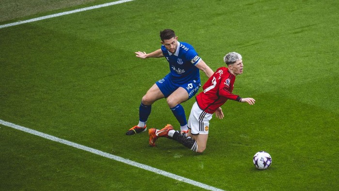 MANCHESTER, ENGLAND - MARCH 09: Alejandro Garnacho of Manchester United is fouled by James Tarkowski of Everton FC during the Premier League match between Manchester United and Everton FC at Old Trafford on March 09, 2024 in Manchester, England. (Photo by Ash Donelon/Manchester United via Getty Images)
