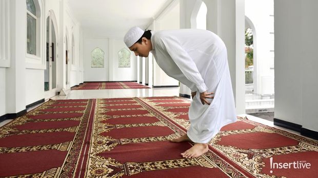 Religious muslim man praying inside the mosque