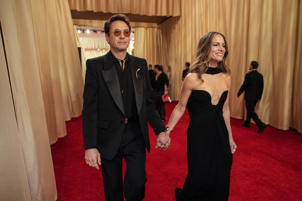 Susan Downey, left, and Robert Downey Jr. arrive at the Oscars on Sunday, March 10, 2024, at the Dolby Theatre in Los Angeles. (Photo by Jordan Strauss/Invision/AP)