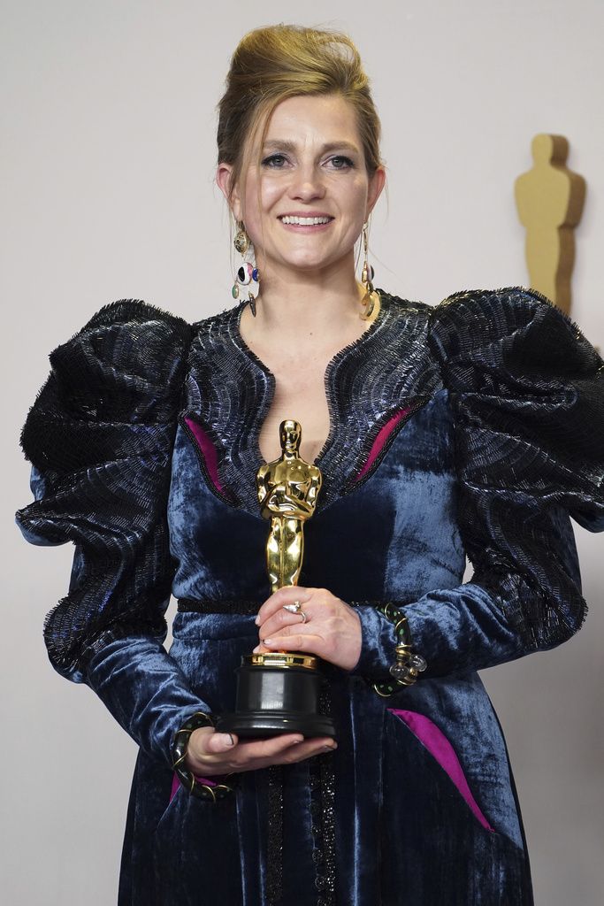 Holly Waddington poses with the award for best costume design for 