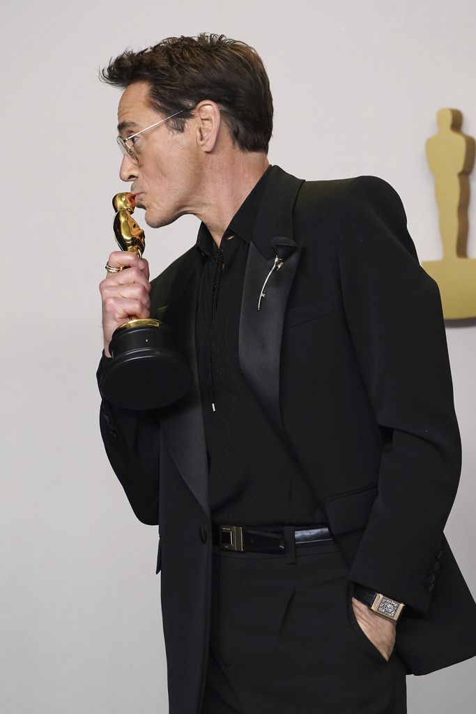 Robert Downey Jr. poses in the press room with the award for best performance by an actor in a supporting role for 