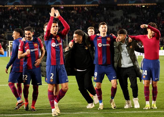 Soccer Football - Champions League - Round of 16 - Second Leg - FC Barcelona v Napoli - Estadi Olimpic Lluis Companys, Barcelona, Spain - March 12, 2024 FC Barcelonas Joao Cancelo and teammates celebrate after the match REUTERS/Nacho Doce