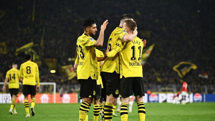 DORTMUND, GERMANY - MARCH 13: Marco Reus of Borussia Dortmund celebrates scoring his teams second goal with teammates Emre Can and Niklas Suele (obscured) during the UEFA Champions League 2023/24 round of 16 second leg match between Borussia Dortmund and PSV Eindhoven at Signal Iduna Park on March 13, 2024 in Dortmund, Germany. (Photo by Alexander Scheuber - UEFA/UEFA via Getty Images)
