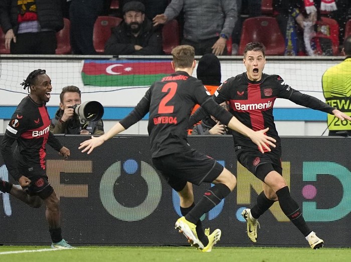 Leverkusen's Patrik Schick, right, celebrates after scoring his side's third goal during the Europa League round of sixteen, second leg, soccer match between Bayer Leverkusen and Qarabag FK at the BayArena in Leverkusen, Germany, Thursday, March 14, 2024. (AP Photo/Martin Meissner)