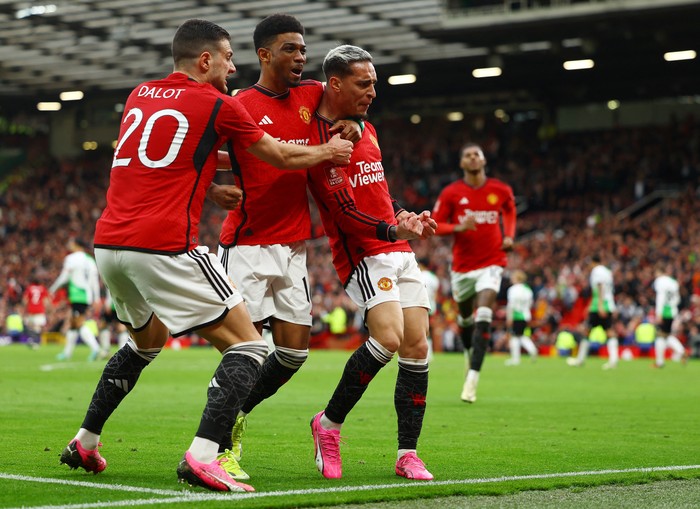 Soccer Football - FA Cup - Quarter Final - Manchester United v Liverpool - Old Trafford, Manchester, Britain - March 17, 2024 Manchester Uniteds Antony celebrates scoring their second goal with Amad Diallo and Diogo Dalot REUTERS/Molly Darlington