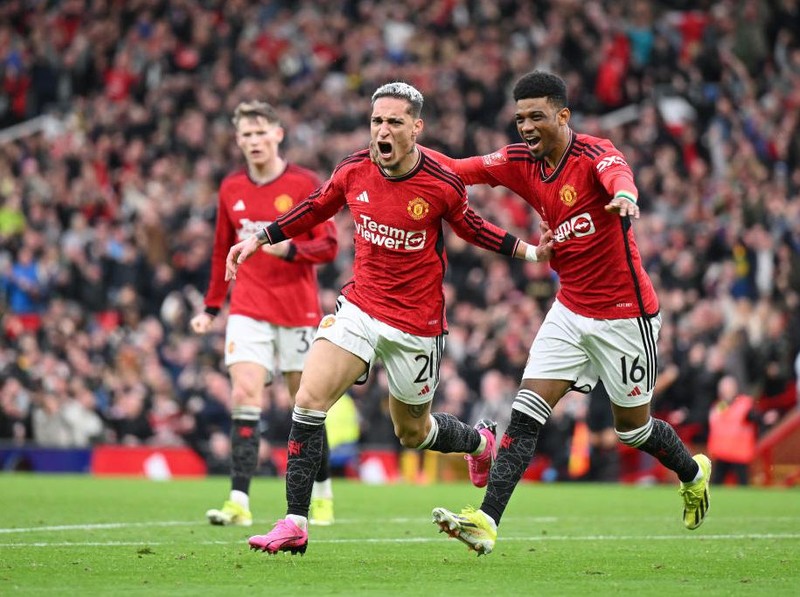 MANCHESTER, ENGLAND - MARCH 17: Antony of Manchester United celebrates scoring his team's second goal with teammate Amad Diallo during the Emirates FA Cup Quarter Final between Manchester United and Liverpool FC at Old Trafford on March 17, 2024 in Manchester, England. (Photo by Michael Regan/Getty Images)