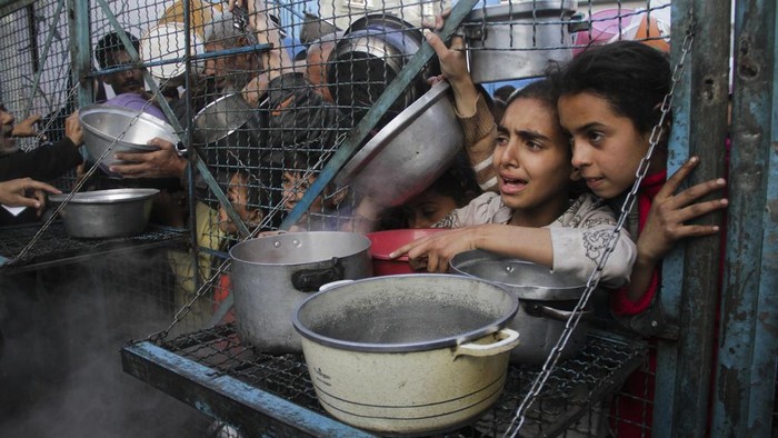 Palestinians line up to receive free meals at Jabaliya refugee camp in the Gaza Strip on Monday, March 18, 2024. (AP Photo/Mahmoud Essa)