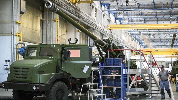 An employee walks by a Caesar truck at the NEXTER factory in Roanne, central France. (Photo by OLIVIER CHASSIGNOLE / AFP)