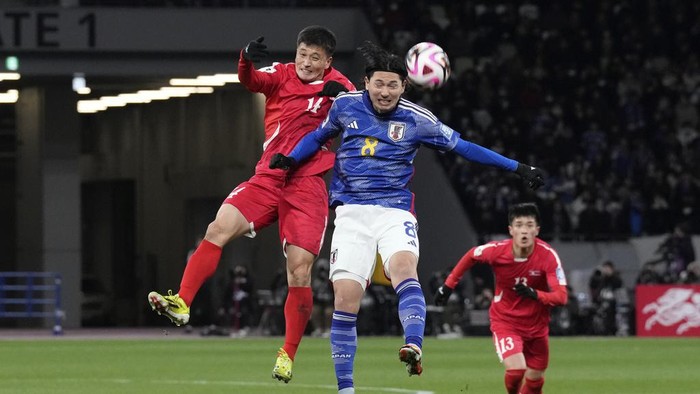 Japans Takumi Minamino, right, competes for the ball with North Koreas Choe Ok Chol during the FIFA World Cup 2026 and AFC Asian Cup 2027 preliminary joint qualification round 2 match between Japan and North Korea at the National Stadium Thursday, March 21, 2024, in Tokyo. (AP Photo/Eugene Hoshiko)