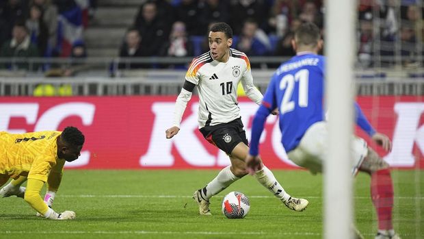 Germany's Jamal Musiala in action during an international friendly soccer match between France and Germany at the Groupama stadium in Decines, near Lyon, central France, Saturday, March 23, 2024. (AP Photo/Laurent Cipriani)