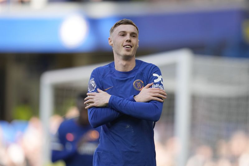 Chelsea's Cole Palmer celebrates after scoring the opening goal from the penalty spot during the English Premier League soccer match between Chelsea and Burnley at Stamford Bridge in London, Saturday, March 30, 2024. (AP Photo/Kin Cheung)