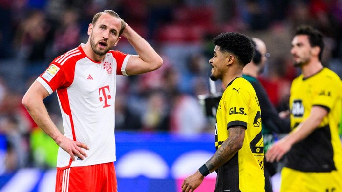 30 March 2024, Bavaria, Munich: Soccer: Bundesliga, Bayern Munich - Borussia Dortmund, Matchday 27, Allianz Arena. Munichs Harry Kane (l) reacts unhappily after the game. Photo: Tom Weller/dpa - IMPORTANT NOTE: In accordance with the regulations of the DFL German Football League and the DFB German Football Association, it is prohibited to utilize or have utilized photographs taken in the stadium and/or of the match in the form of sequential images and/or video-like photo series. (Photo by Tom Weller/picture alliance via Getty Images)