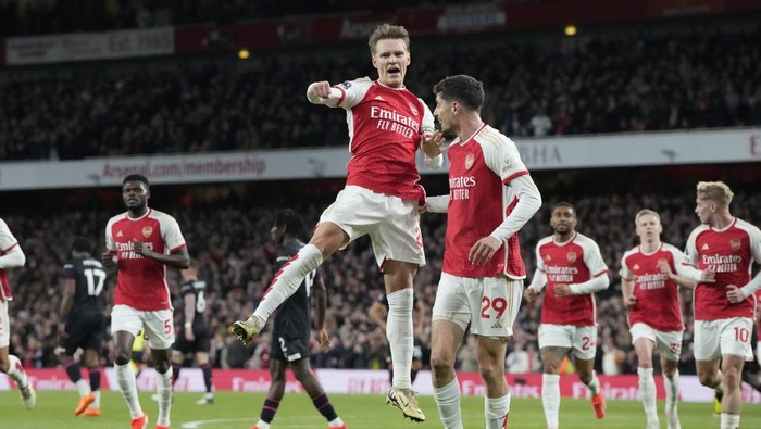 Arsenals Martin Odegaard celebrates after scoring his sides opening goal during the English Premier League soccer match between Arsenal and Luton Town at the Emirates Stadium, London, Wednesday, Apr. 3, 2024. (AP Photo/Frank Augstein)