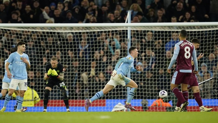 Manchester Citys Phil Foden runs as he celebrates after scoring his third goal of the match during the English Premier League soccer match between Manchester City and Aston Villa at the Etihad Stadium in Manchester, England, Wednesday, April 3, 2024. (AP Photo/Dave Thompson)