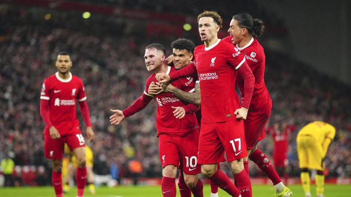 Liverpool players celebrate after Liverpools Alexis Mac Allister scored his sides second goal during the English Premier League soccer match between Liverpool and Sheffield United at the Anfield stadium in Liverpool, England, Thursday, Apr. 4, 2024. (AP Photo/Jon Super)