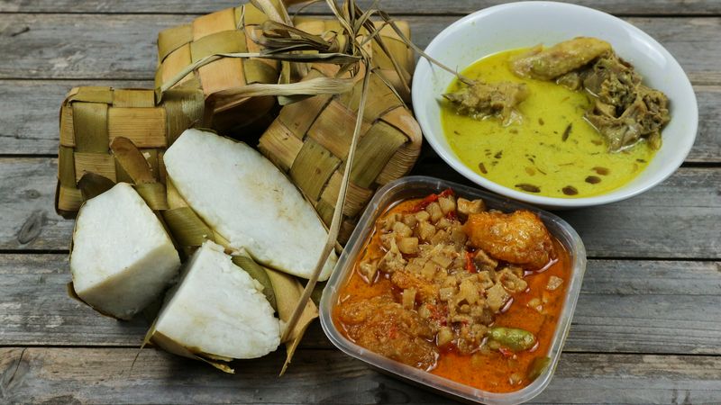 Selected Focus Ketupat Lebaran, served with Sambal Goreng Kentang, Opor Ayam and Telur Semur. Traditional Celebratory Menu during Eid al-Fitr and Eid al-Adha in Indonesia