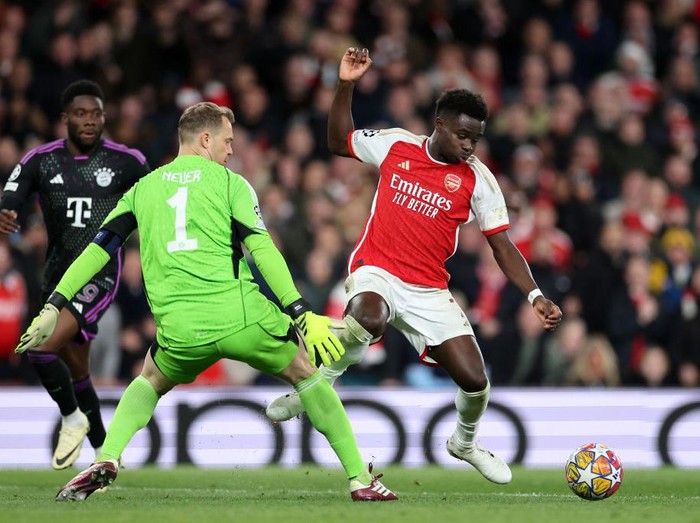 LONDON, ENGLAND - APRIL 09: Bukayo Saka of Arsenal is tackled by Manuel Neuer of Bayern Munich during the UEFA Champions League quarter-final first leg match between Arsenal FC and FC Bayern München at Emirates Stadium on April 09, 2024 in London, England. (Photo by Jan Kruger - UEFA/UEFA via Getty Images)