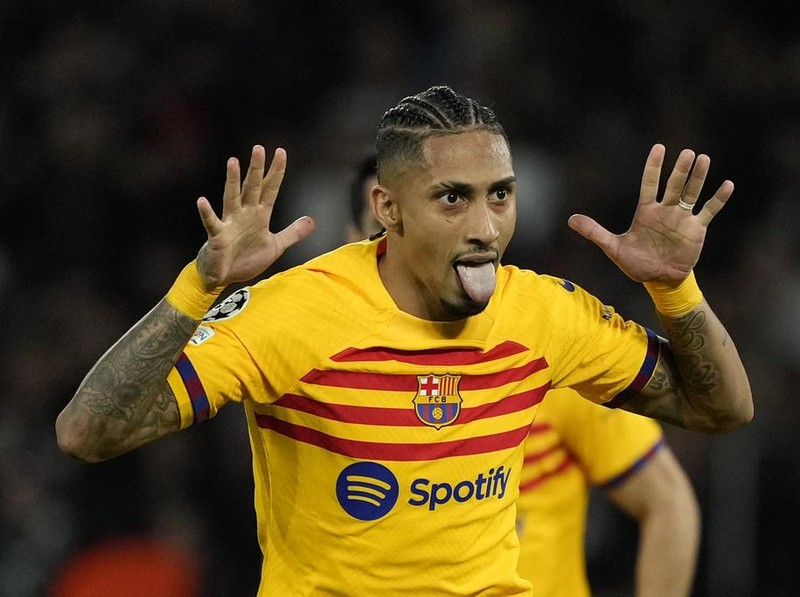Barcelona's Raphinha celebrates after scoring his side's opening goal during the Champions League quarterfinal first leg soccer match between Paris Saint-Germain and Barcelona at the Parc des Princes stadium in Paris, Wednesday, April 10, 2024. (AP Photo/Lewis Joly)