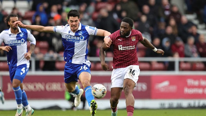 NORTHAMPTON, ENGLAND - FEBRUARY 17:  Tyreece Simpson of Northampton Town plays the ball away from Elkan Baggott of Bristol Rovers during the Sky Bet League One match between Northampton Town and Bristol Rovers at Sixfields on February 17, 2024 in Northampton, England. (Photo by Pete Norton/Getty Images)