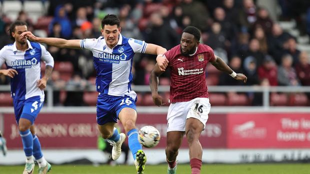 NORTHAMPTON, ENGLAND - FEBRUARY 17:  Tyreece Simpson of Northampton Town plays the ball away from Elkan Baggott of Bristol Rovers during the Sky Bet League One match between Northampton Town and Bristol Rovers at Sixfields on February 17, 2024 in Northampton, England. (Photo by Pete Norton/Getty Images)