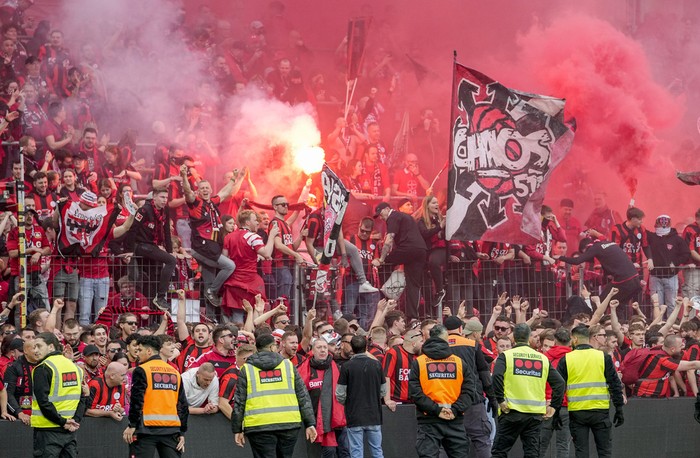 Leverkusen fans celebrate after Bayer Leverkusen won the German Bundesliga title beating Werder Bremen in Leverkusen, Germany, Sunday, April 14, 2024. (AP Photo/Martin Meissner)