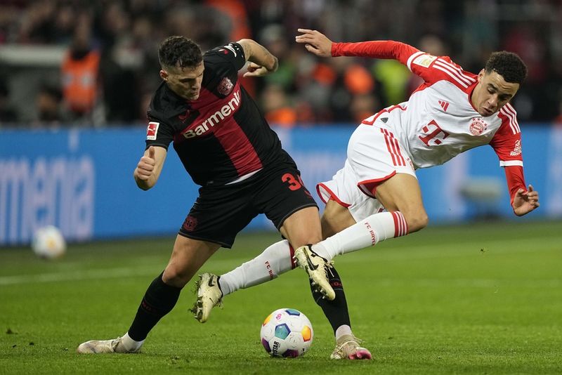 Leverkusen's Granit Xhaka celebrates after winning the German Bundesliga soccer match between Bayer Leverkusen and TSG Hoffenheim at the BayArena in Leverkusen, Germany, Saturday, March 30, 2024. (AP Photo/Martin Meissner)