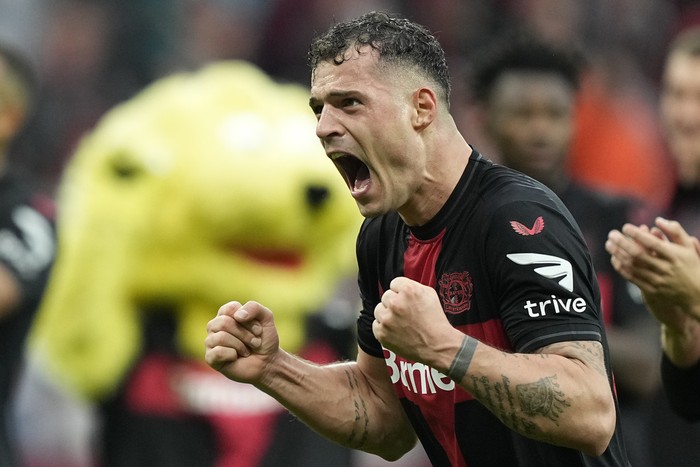 Leverkusens Granit Xhaka celebrates after winning the German Bundesliga soccer match between Bayer Leverkusen and TSG Hoffenheim at the BayArena in Leverkusen, Germany, Saturday, March 30, 2024. (AP Photo/Martin Meissner)