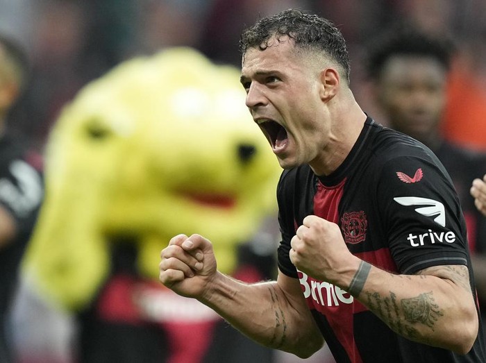Leverkusen's Granit Xhaka celebrates after winning the German Bundesliga soccer match between Bayer Leverkusen and TSG Hoffenheim at the BayArena in Leverkusen, Germany, Saturday, March 30, 2024. (AP Photo/Martin Meissner)