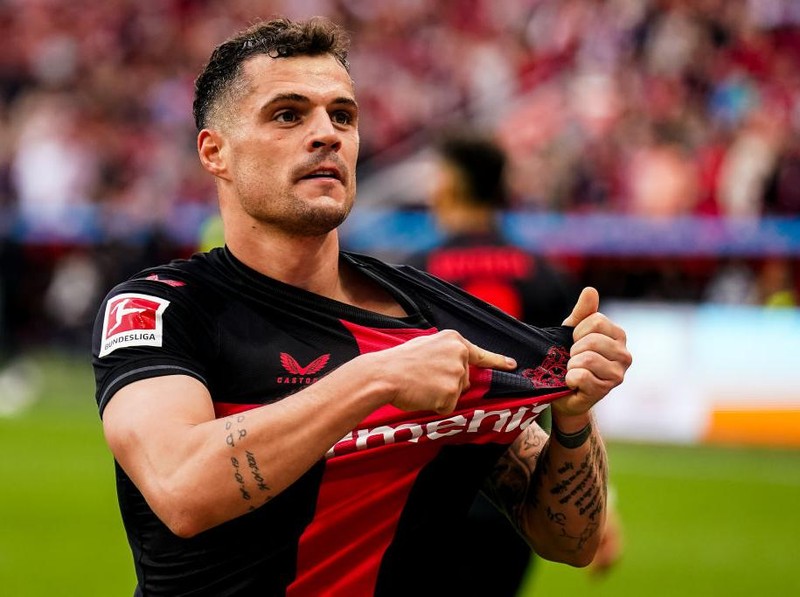 LEVERKUSEN, GERMANY - APRIL 14: Granit Xhaka of Bayer 04 Leverkusen celebrates after scoring his team's second goal during the Bundesliga match between Bayer 04 Leverkusen and SV Werder Bremen at BayArena on April 14, 2024 in Leverkusen, Germany.(Photo by Rene Nijhuis/MB Media/Getty Images)