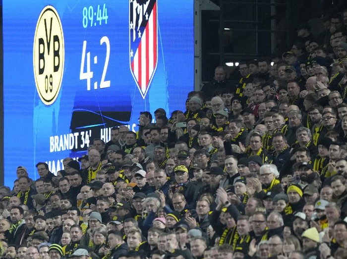 A screen shows the result behind supporters during the Champions League quarterfinal second leg soccer match between Borussia Dortmund and Atletico Madrid at the Signal-Iduna Park in Dortmund, Germany, Tuesday, April 16, 2024(AP Photo/Martin Meissner)
