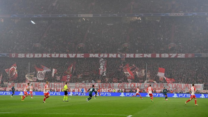 MUNICH, GERMANY - APRIL 17: Bayern Munich unveil a banner reading we dont like you either exclusive UEFA! Get out of our stadium! during the UEFA Champions League quarter-final second leg match between FC Bayern München and Arsenal FC at Allianz Arena on April 17, 2024 in Munich, Germany. (Photo by Justin Setterfield/Getty Images)
