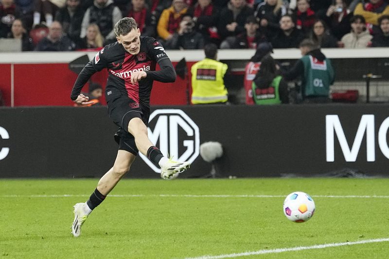 Leverkusen's Florian Wirtz scores his side's second goal during the German Bundesliga soccer match between Bayer Leverkusen and VfL Wolfsburg at the BayArena in Leverkusen, Germany, Sunday, March 10, 2024. (AP Photo/Martin Meissner)