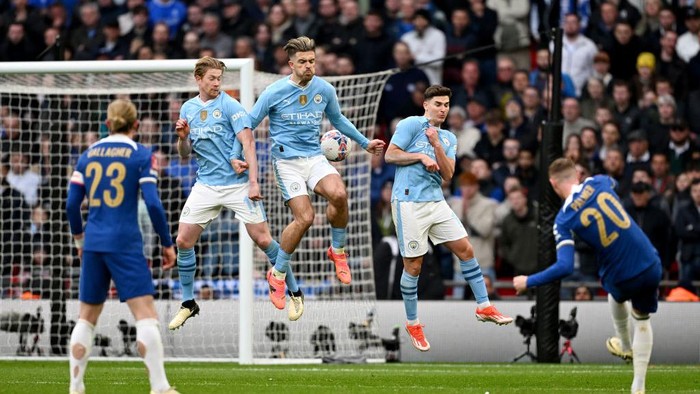 LONDON, ENGLAND - APRIL 20: Kevin De Bruyne, Jack Grealish and Julian Alvarez of Manchester City jump in the wall as Cole Palmer of Chelsea takes a free kick during the Emirates FA Cup Semi Final match between Manchester City and Chelsea at Wembley Stadium on April 20, 2024 in London, England. (Photo by Michael Regan - The FA/The FA via Getty Images)