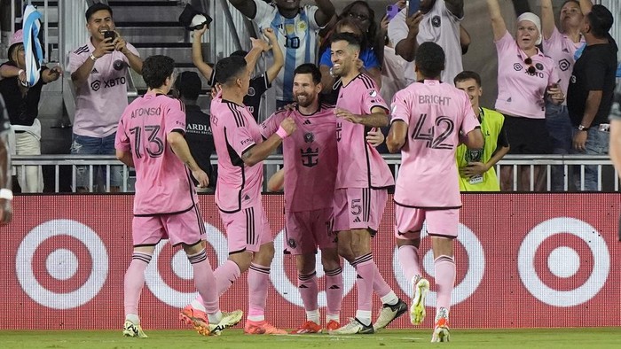 Inter Miami forward Lionel Messi, middle, is congratulated by teammates after scoring on a penalty kick against Nashville SC during the second half of an MLS soccer match Saturday, April 20, 2024, in Fort Lauderdale, Fla. (AP Photo/Marta Lavandier)