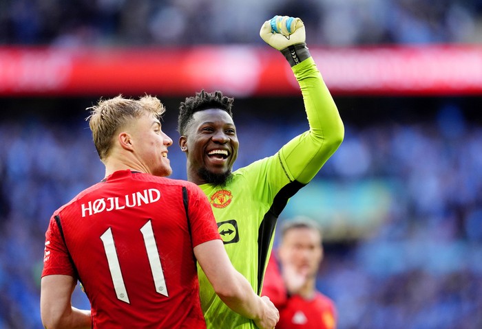 Manchester Uniteds Rasmus Hojlund (left) and goalkeeper Andre Onana celebrate at the end of the English FA Cup semifinal soccer match between Coventry City and Manchester United at Wembley stadium in London, Sunday, April 21, 2024. (Nick Potts/PA via AP)