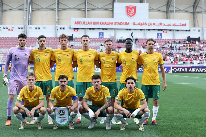 DOHA, QATAR - APRIL 15:  Team Australia players pose for a group photo before the AFC U23 Asian Cup Group A match between Australia and Jordan at Abdullah bin Khalifa Stadium on April 15, 2024 in Doha, Qatar. (Photo by Mohamed Farag/Getty Images)