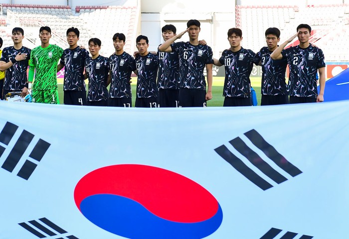 The South Korean players are standing for the national anthem ahead of the AFC U23 Asian Cup Qatar 2024 Group B match between China and South Korea at Abdullah Bin Khalifa Stadium in Doha, Qatar, on April 19, 2024. (Photo by Noushad Thekkayil/NurPhoto via Getty Images)