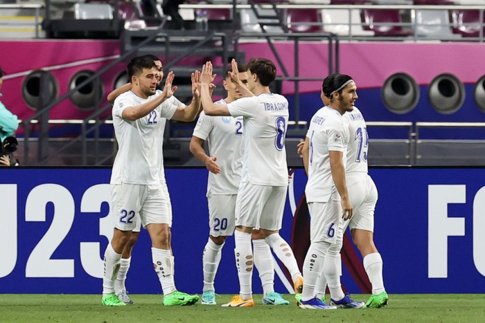 DOHA, QATAR - APRIL 23: Alisher Odilov #22 of Uzbekistan celebrates his first goal with teammates during the AFC U23 Asian Cup Group D match between Uzbekistan and Vietnam at Khalifa International Stadium on April 23, 2024 in Doha, Qatar.  (Photo by Zhizhao Wu/Getty Images)