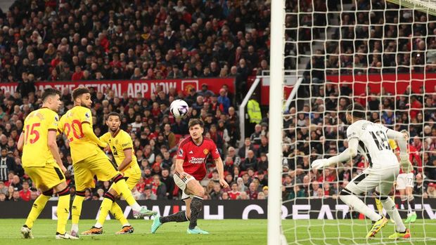 MANCHESTER, ENGLAND - APRIL 24: Harry Maguire of Manchester United scores his team's first goal past Wes Foderingham of Sheffield United during the Premier League match between Manchester United and Sheffield United at Old Trafford on April 24, 2024 in Manchester, England. (Photo by Matt McNulty/Getty Images)