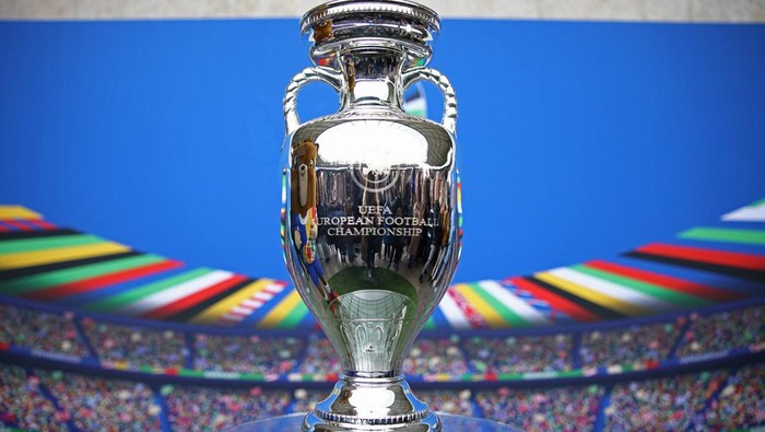 Soccer Football - Euro 2024 - Trophy Display at Olympiastadion - Olympiastadion, Berlin, Germany - April 24, 2024 Euro 2024 mascot Albart poses with the European Championship trophy REUTERS/Liesa Johannssen