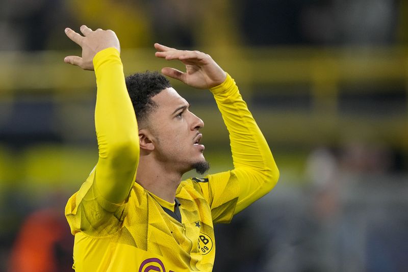 Dortmund's Jadon Sancho celebrates after scoring his side's opening goal during the Champions League round of 16 second leg soccer match between Borussia Dortmund and PSV Eindhoven at the Signal Iduna Park in Dortmund, Germany, Wednesday, March 13, 2024. (AP Photo/Martin Meissner)