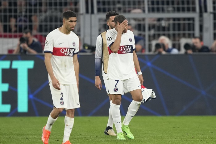 PSGs Kylian Mbappe, center, and teammate Achraf Hakimi leave the pitch after the Champions League semifinal first leg soccer match between Borussia Dortmund and Paris Saint-Germain at the Signal-Iduna Park in Dortmund, Germany, Wednesday, May 1, 2024. (AP Photo/Martin Meissner)
