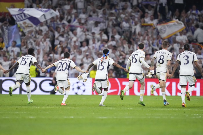 Real Madrid players celebrate at the end of the Champions League semifinal second leg soccer match between Real Madrid and Bayern Munich at the Santiago Bernabeu stadium in Madrid, Spain, Wednesday, May 8, 2024. (AP Photo/Manu Fernandez)