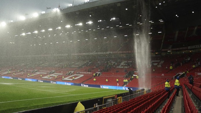 The rain comes down from the roof at the Old Trafford stadium at the end of the English Premier League soccer match between Manchester United and Arsenal, in Manchester, England, Sunday, May 12, 2024. Arsenal won 1-0. (AP Photo/Dave Thompson)