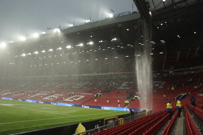 The rain comes down from the roof at the Old Trafford stadium at the end of the English Premier League soccer match between Manchester United and Arsenal, in Manchester, England, Sunday, May 12, 2024. Arsenal won 1-0. (AP Photo/Dave Thompson)