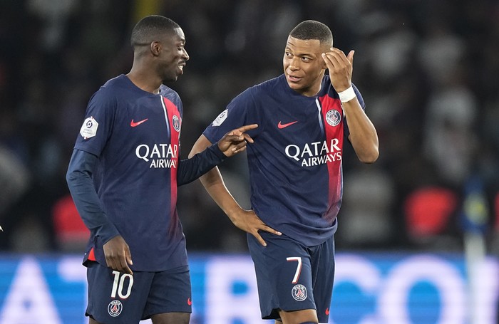 PSGs Ousmane Dembele, left, and Kylian Mbappe talk after the French League One soccer match between Paris Saint-Germain and Lens at the Parc des Princes stadium in Paris, Saturday, Aug. 26, 2023. (AP Photo/Michel Euler)